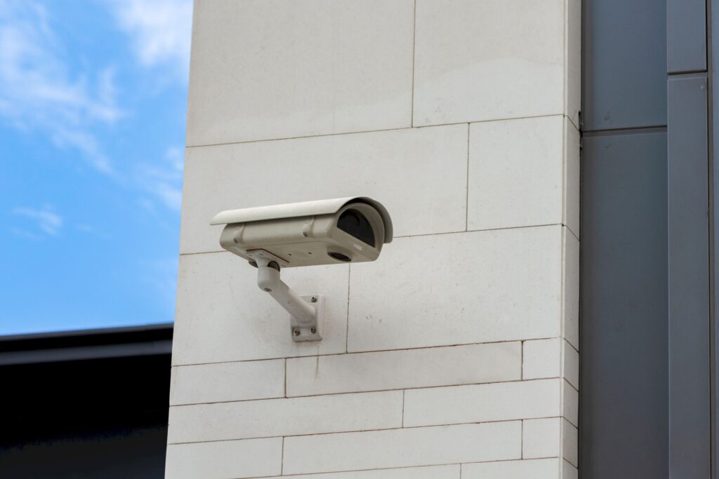 Surveillance camera built into the stone wall of the building, close up